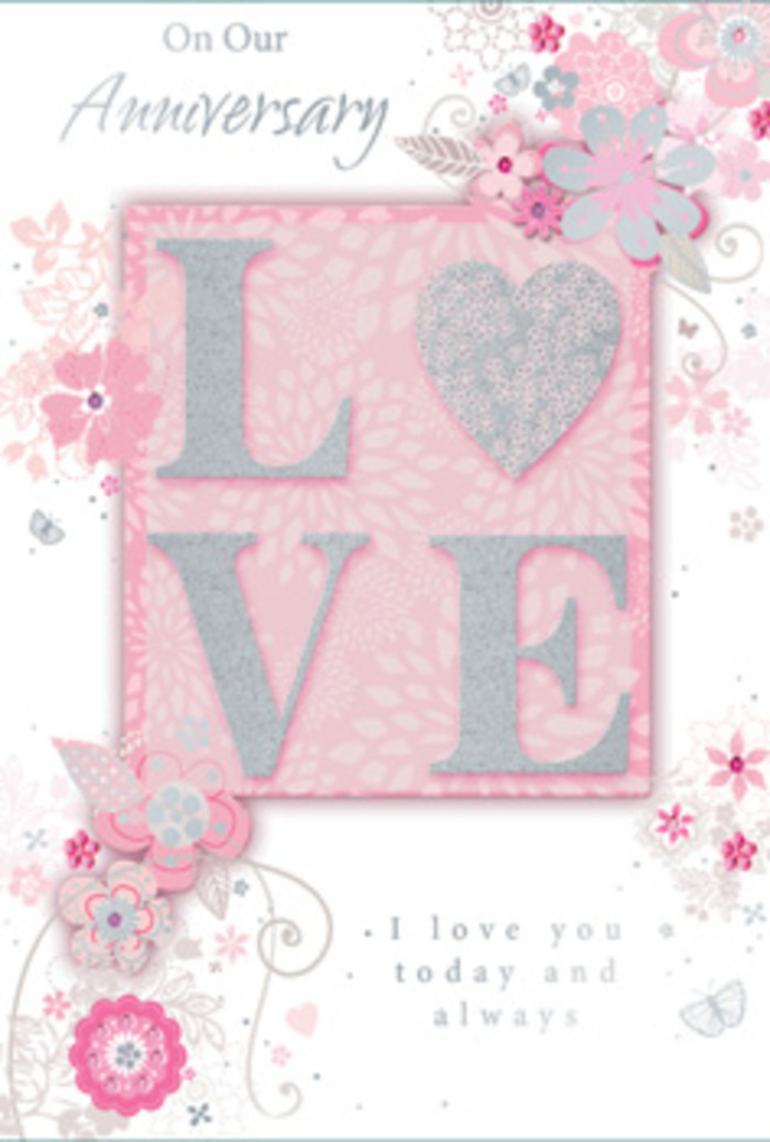 In this image, an anniversary card is shown in full, its design evoking the gentle romance of pastel flowers you might see in a Deptford Flowers window display. Centre stage is the word LOVE, spelled out in tall, block capitals that rise subtly from the surface of the card. The letters are generously coated in fine, shimmering glitter in pale pink and silver tones, creating a tactile, almost crystalline effect. When light touches the glitter, it scatters tiny reflections, giving the impression of delicate frost or dew resting on petals at first light. The central word sits on a pale blush-pink panel, bordered softly by the surrounding field of powder pink that extends to the edges of the card. Around this focal point, a cascade of stylised blossoms and swirling foliage unfolds. Slender stems bend into elegant curves, supporting blossoms drawn with fine, delicate lines. The petals are coloured in muted blush, ivory, and gentle grey, with subtle silver tracing that adds glints of light along the contours. Though abstracted, the arrangement suggests a thoughtfully composed bouquet, with clusters of flowers and leaves radiating outwards, yet leaving space to breathe so the design never feels crowded. The background pink is smooth and velvety in appearance, offering a soothing contrast to the raised, sparkling letters and intricate line work. Dainty scrolls and ornamental flourishes intertwine with the floral motifs, echoing the movement of trailing greenery in a hand-tied anniversary arrangement. An elegantly scripted message is integrated into the design, its looping letters echoing the floral swirls. The overall effect is one of tender celebration and enduring love-a paper expression of devotion, reminiscent of pastel blooms carried home from Deptford Market Yard to mark another cherished year together.