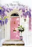 This photograph portrays an inviting Deptford doorway dressed in soft, romantic florals, evoking the quiet happiness of arriving at a new home. At the centre stands a pale pink front door, its colour delicate and comforting, set within whitewashed walls that reflect ambient daylight in a mellow glow similar to the gentle brightness along nearby residential streets off Evelyn Street. Overhead, lavish trails of lavender wisteria descend from above, their clusters of tiny petals forming loose, tumbling garlands. The wisteria frames the door like a natural archway, each drooping stem adding to the impression of a secret garden entrance hidden in the heart of Deptford. A lightly painted shutter, tinted in a coordinating pastel, rests nearby, softening the sharp lines of the architecture. On the step at the base of the door, a grey metal bucket sits solidly, filled to overflowing with white and cream roses. The roses are full-bodied and lush, their layered petals creating a beautiful, cloud-like mass of texture. Threads of soft green foliage wind gently between the blooms, offering subtle contrast and a hint of the outdoors brought right to the doorstep. Around the bucket, a satin pink ribbon is secured in a graceful bow, its ends draping casually along the stone. The interplay of pinks, creams, and greens is understated and harmonious, like a carefully chosen housewarming bouquet delivered to celebrate a move into one of Deptford's characterful homes. The overall ambience is one of gentle optimism and intimate celebration, as though these flowers were placed to quietly mark the beginning of many happy days to come in this new space.